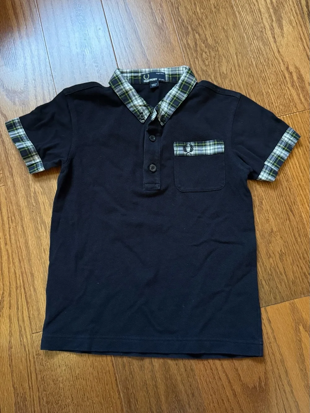 Fred Perry black polo shirt with plaid collar and sleeve cuffs, size 6-7 years